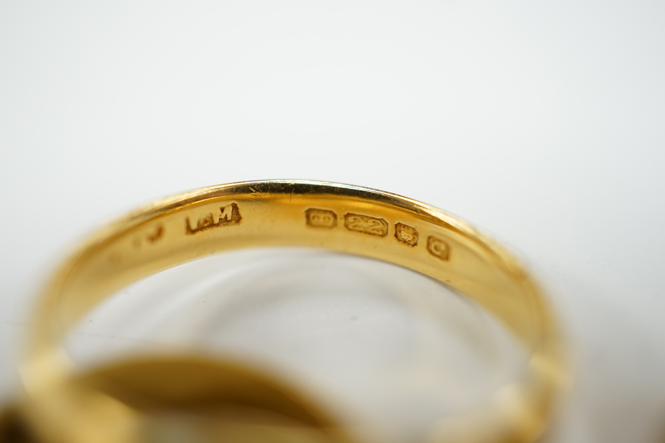Two 22ct gold wedding bands (one cut), 5.8 grams and an 18ct gold buckle ring, 2.9 grams.